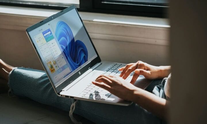 person using Windows 11 computer on lap