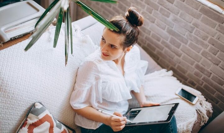 girl in white dress sitting on couch